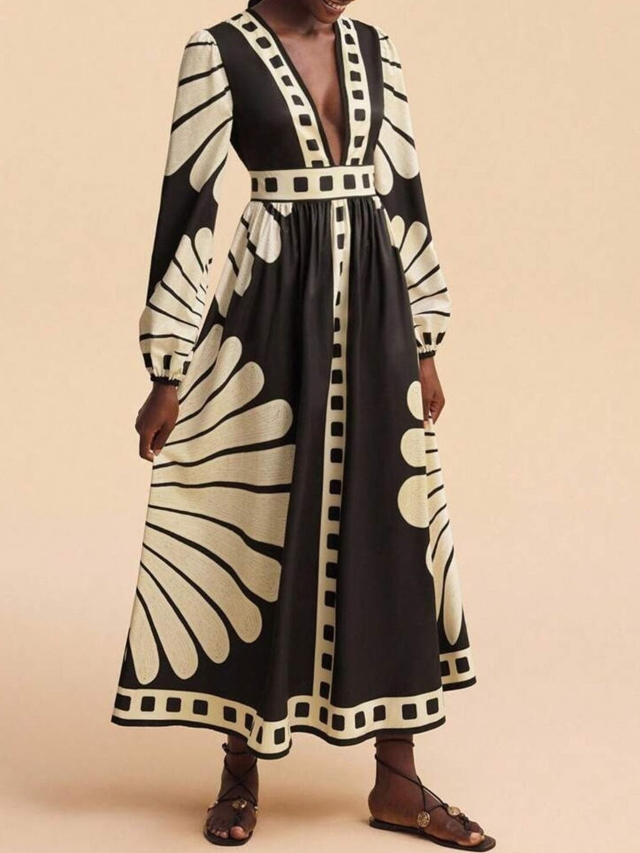 Maxi dress with deep V-neck, long sleeves, and bold black and cream geometric print.
