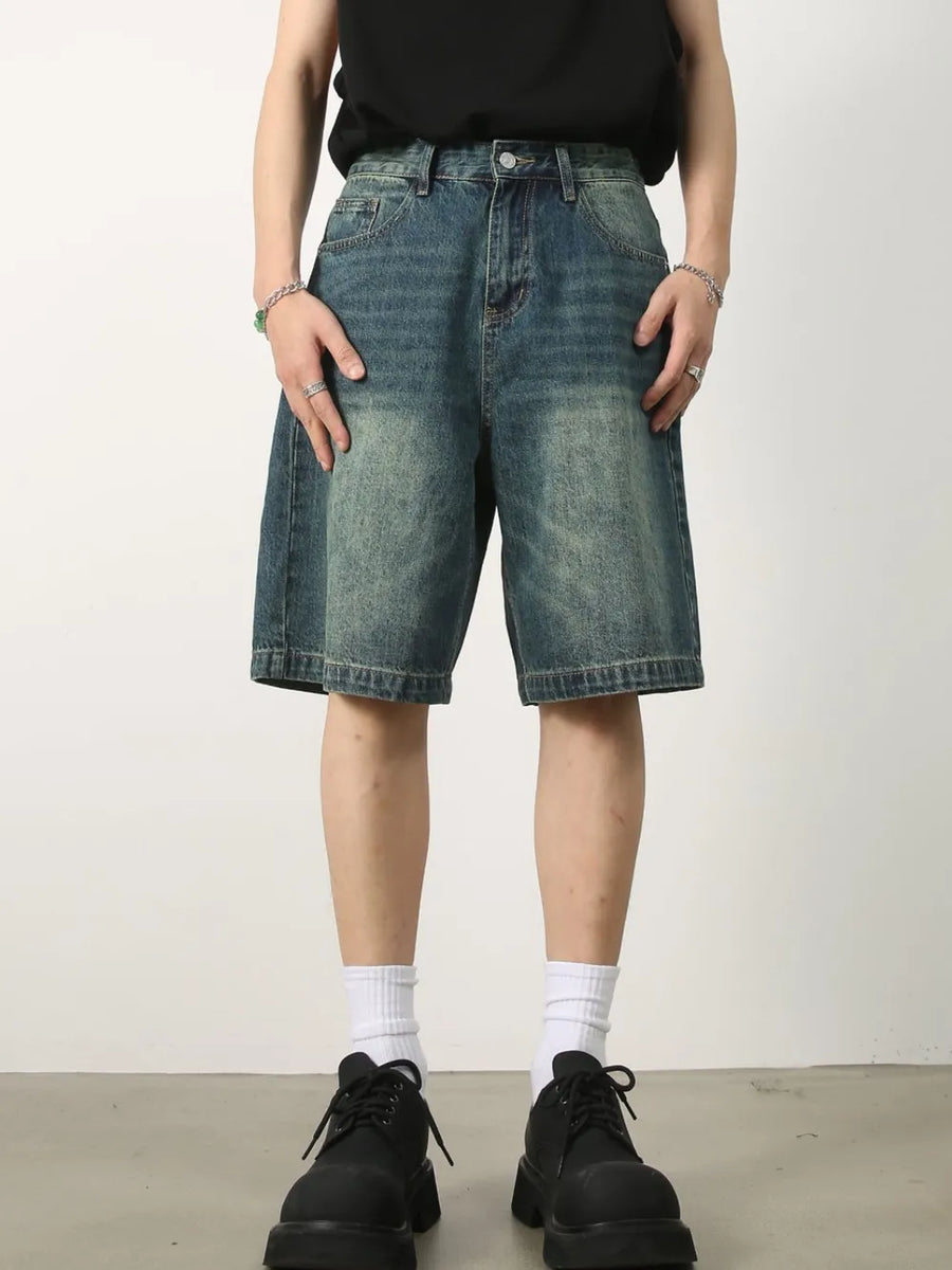 Baggy denim bermuda shorts in light blue with a washed effect and buttoned fly.