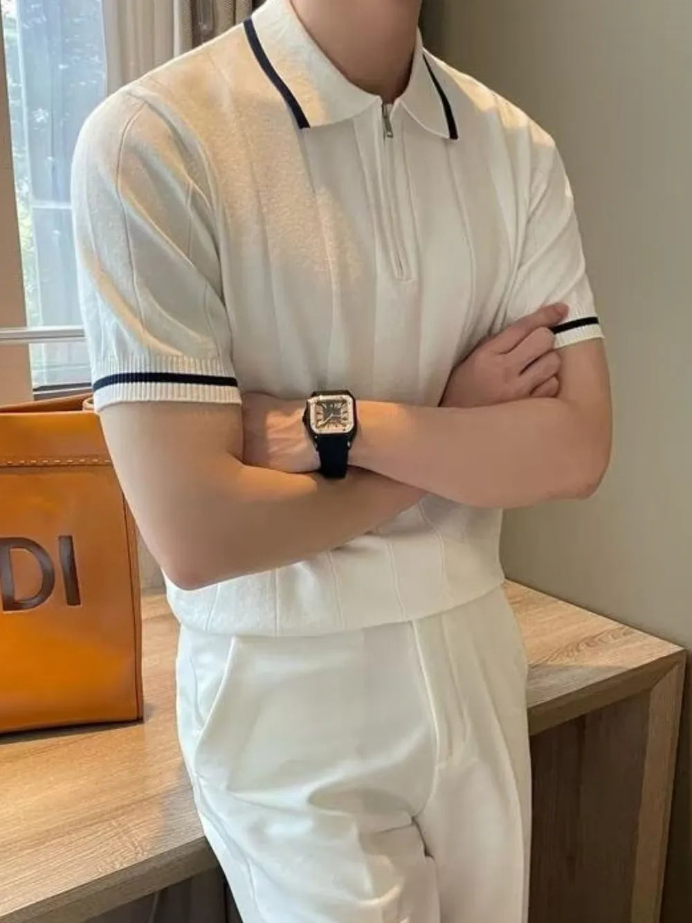 Textured ribbed polo shirt in ivory with contrast trim on collar and sleeves.