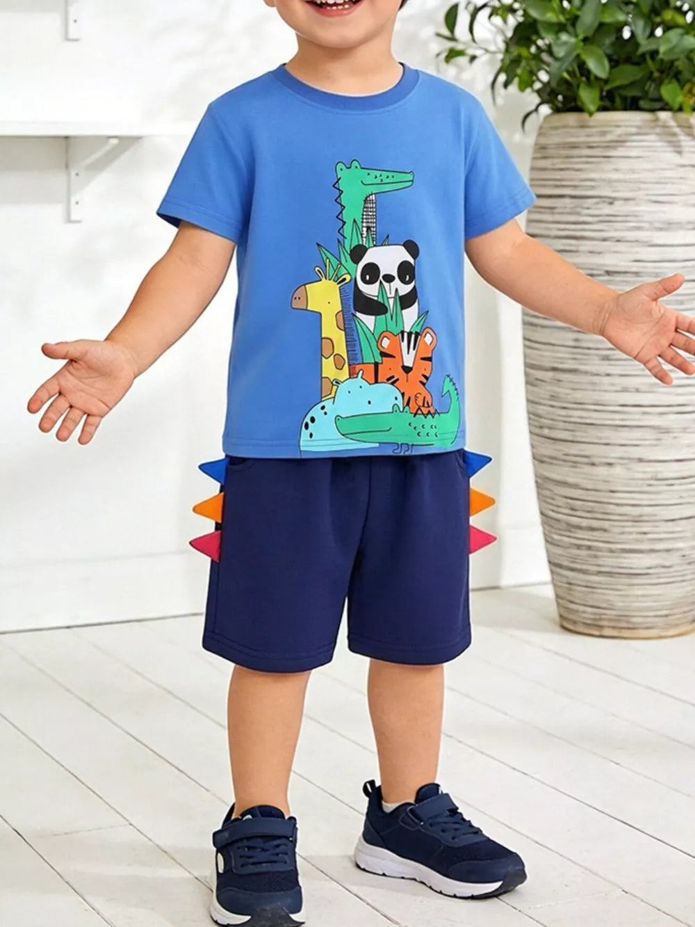 Blue cotton tee with animal print and navy shorts with colorful spikes.