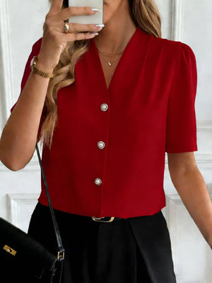 Burgundy V-neck button-down shirt with pearl buttons and short puff sleeves.