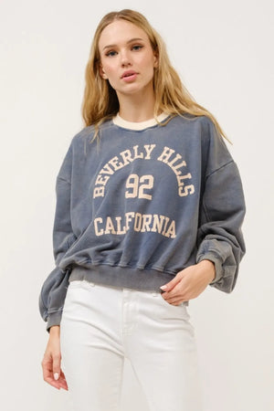 Beverly Hills graphic crop sweatshirt in stone with cream neckline and beige lettering.