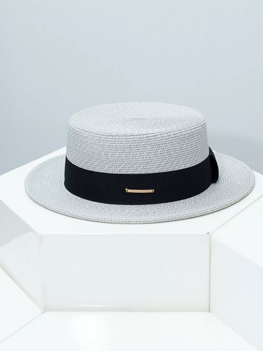 Gray straw boater hat with black ribbon and gold accent detail