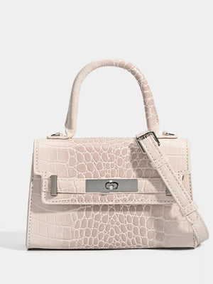 Off-white croc-embossed small tote bag with silver hardware and adjustable strap.