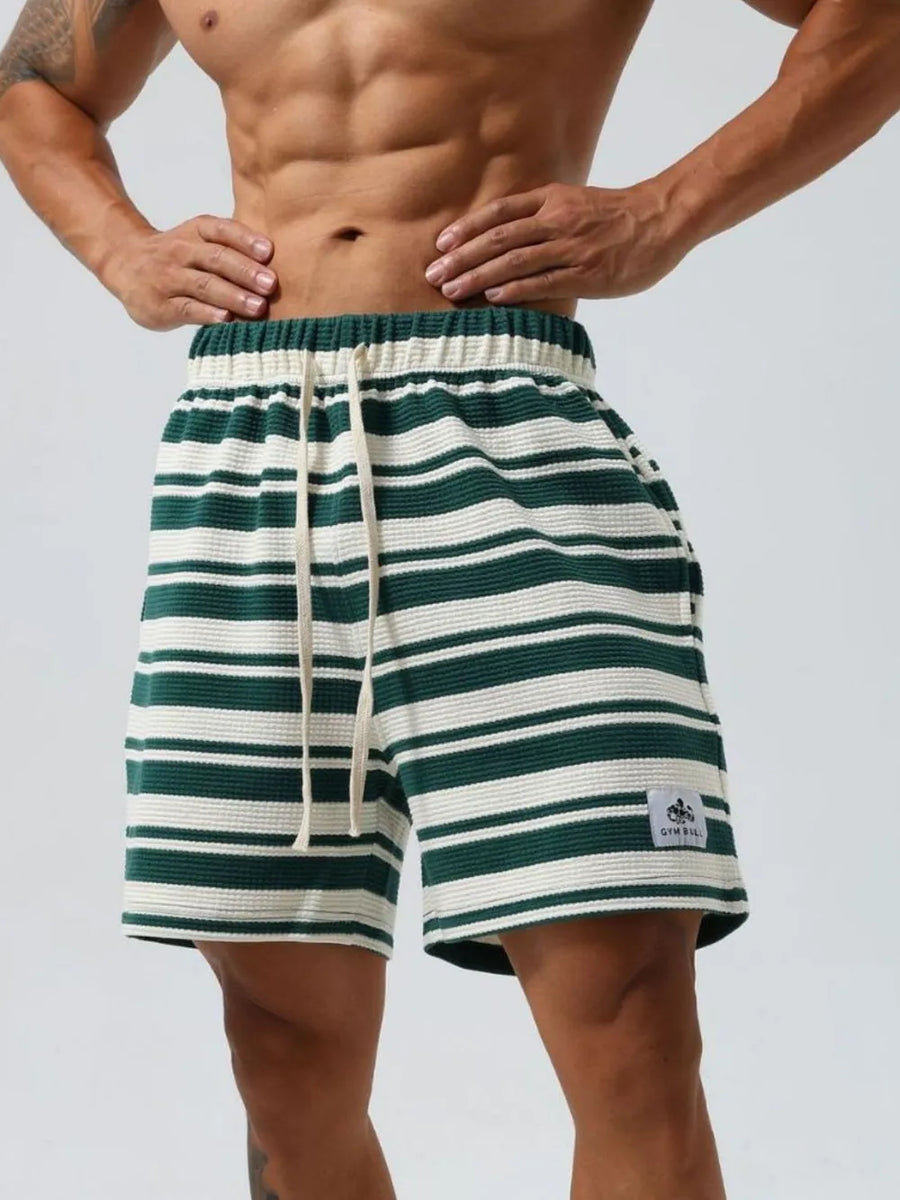 Textured stripe jogger shorts in dark green and white with drawstring and logo patch.