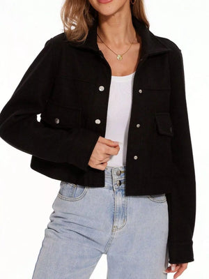 Black trucker jacket with snap buttons and chest pockets, worn over a white tank top.