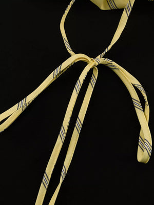 Yellow striped tie-back halter top with thin straps.