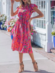 Floral midi dress with ruffled sleeves, V-neck, and tie belt in a cotton blend.
