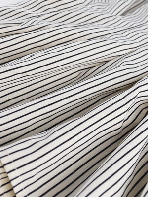 Maternity shirt with black and white stripes, cinched waist detail