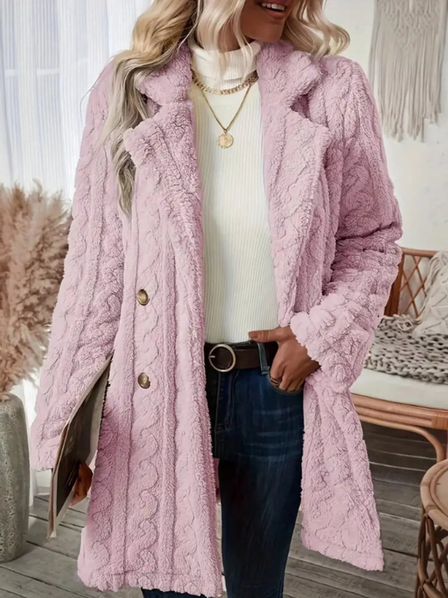 Pink faux shearling double-breasted overcoat with cable knit texture and button closure.