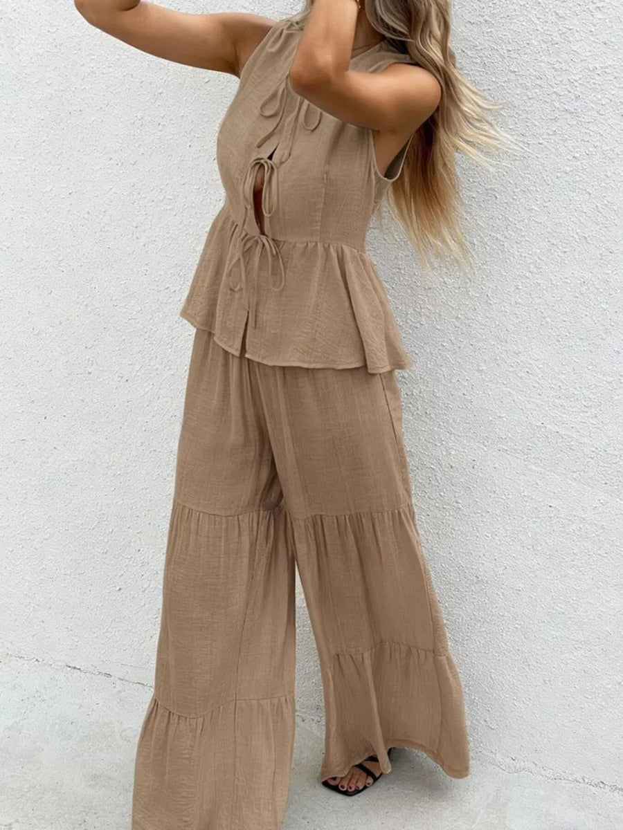 Ruffled tie-front sleeveless top with tiered wide-leg pants set in beige.
