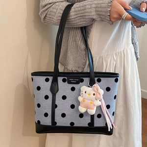 handbag in black with polka dot and top handles