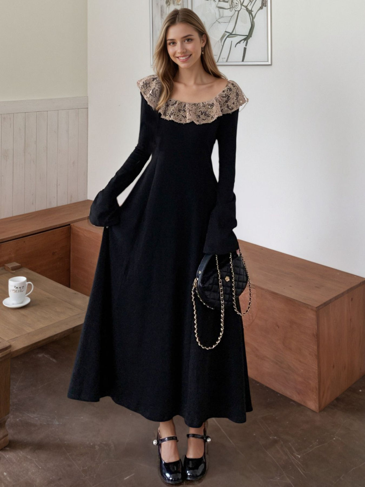 Black A-line dress with lace collar, long sleeves, and bell cuffs.