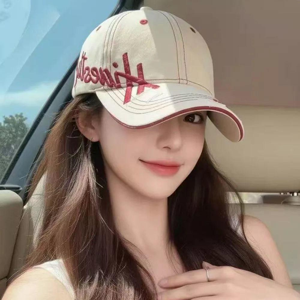 Ivory cotton baseball cap with red embroidery and trim