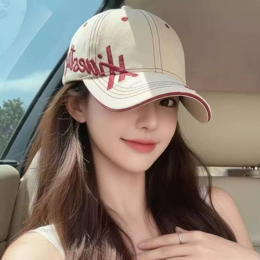 Ivory cotton baseball cap with red embroidery and trim