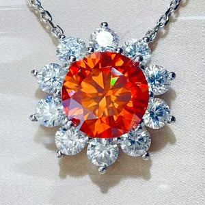 silver necklace featuring pendant and floral