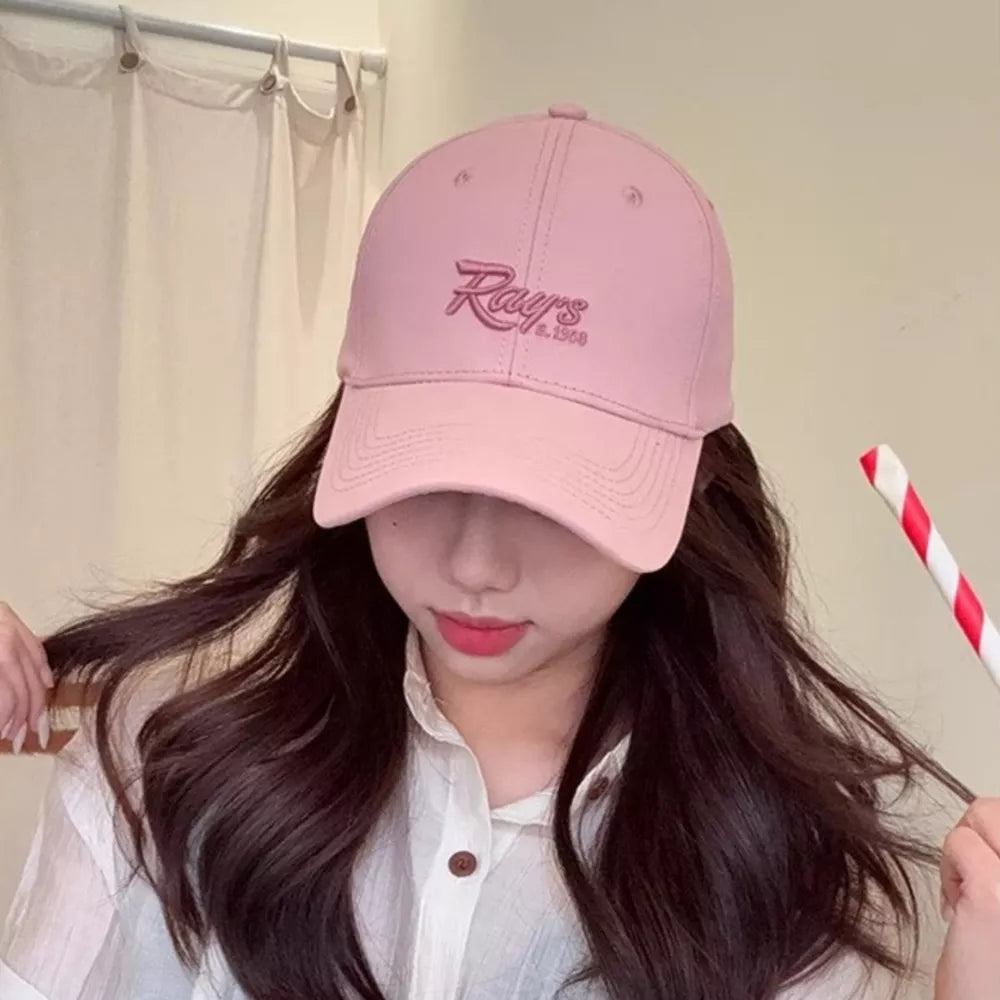Blush pink baseball cap with embroidered "Rays" logo and adjustable strap