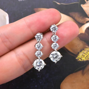 Silver cascade drop earrings with cubic zirconia stones.