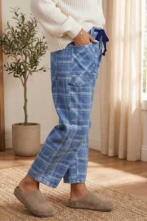 Plaid denim jeans in dusty blue with drawstring waist and grommets.