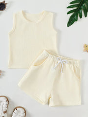 Soft ribbed baby tank top and shorts set in cream with drawstring waist and pockets.