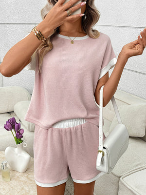 Pink ribbed knit two-piece set with white trim, short sleeves, elastic waistband shorts.