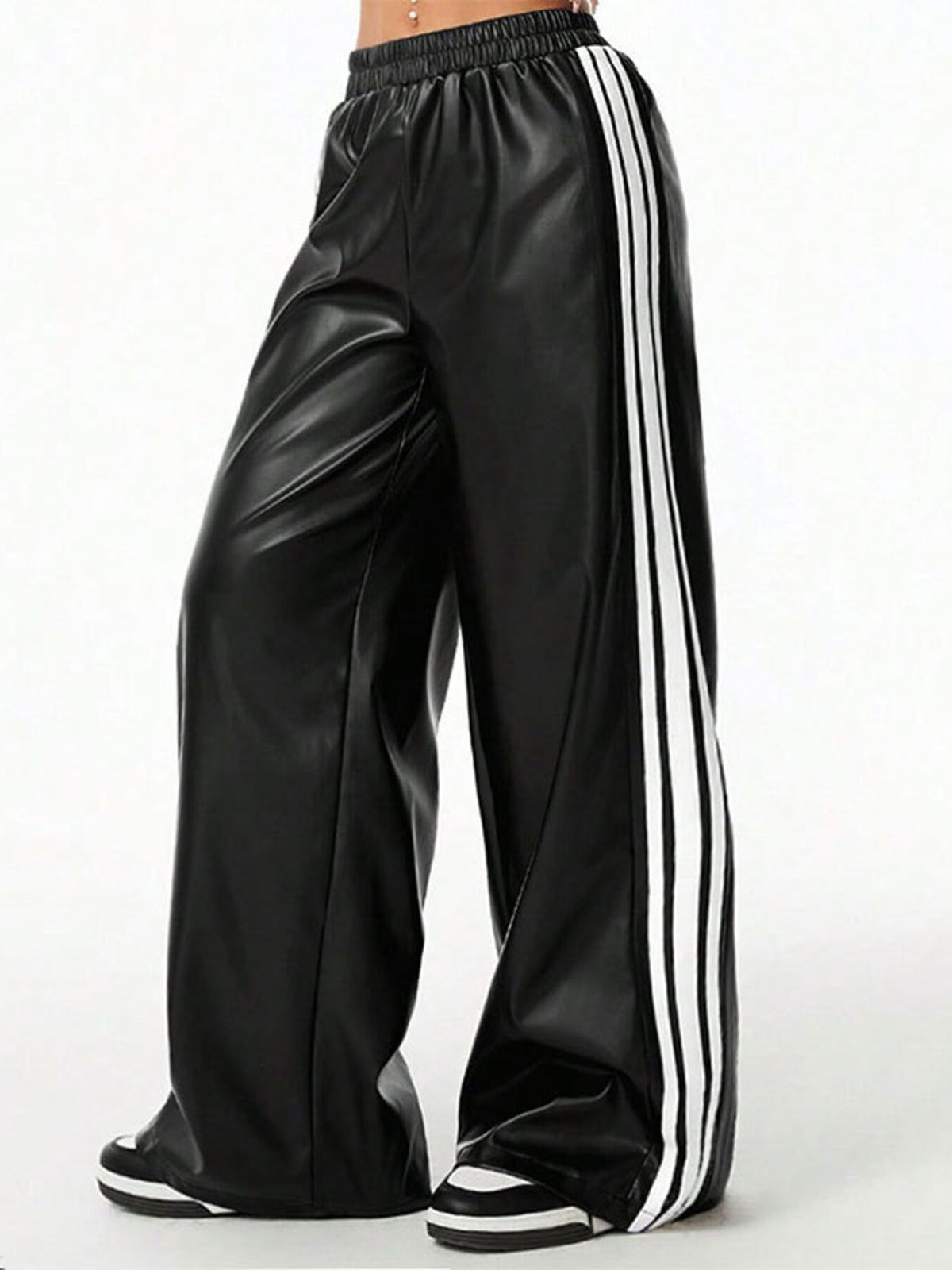 Black faux leather wide leg track pants with white side stripes and elastic waistband