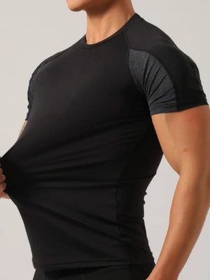 Black activewear t-shirt with textured gray sleeves and round neckline.