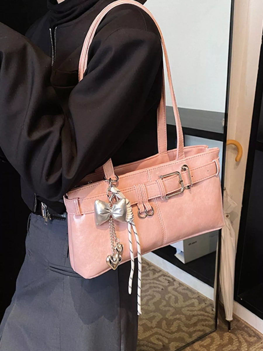 Buckle detail small shoulder bag in blush pink with silver bow and heart charms.