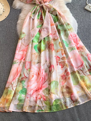 Botanical off-shoulder dress in light pink with a floral rose print and belted waist.