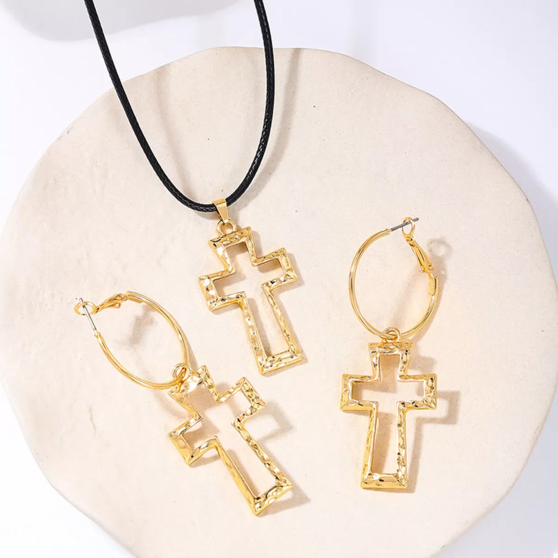 Elegant cross pendant necklace and hoop earrings set in golden 18K gold-plated metal.