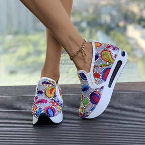 Vibrant slip-on platform sneakers with colorful embroidered paisley pattern.