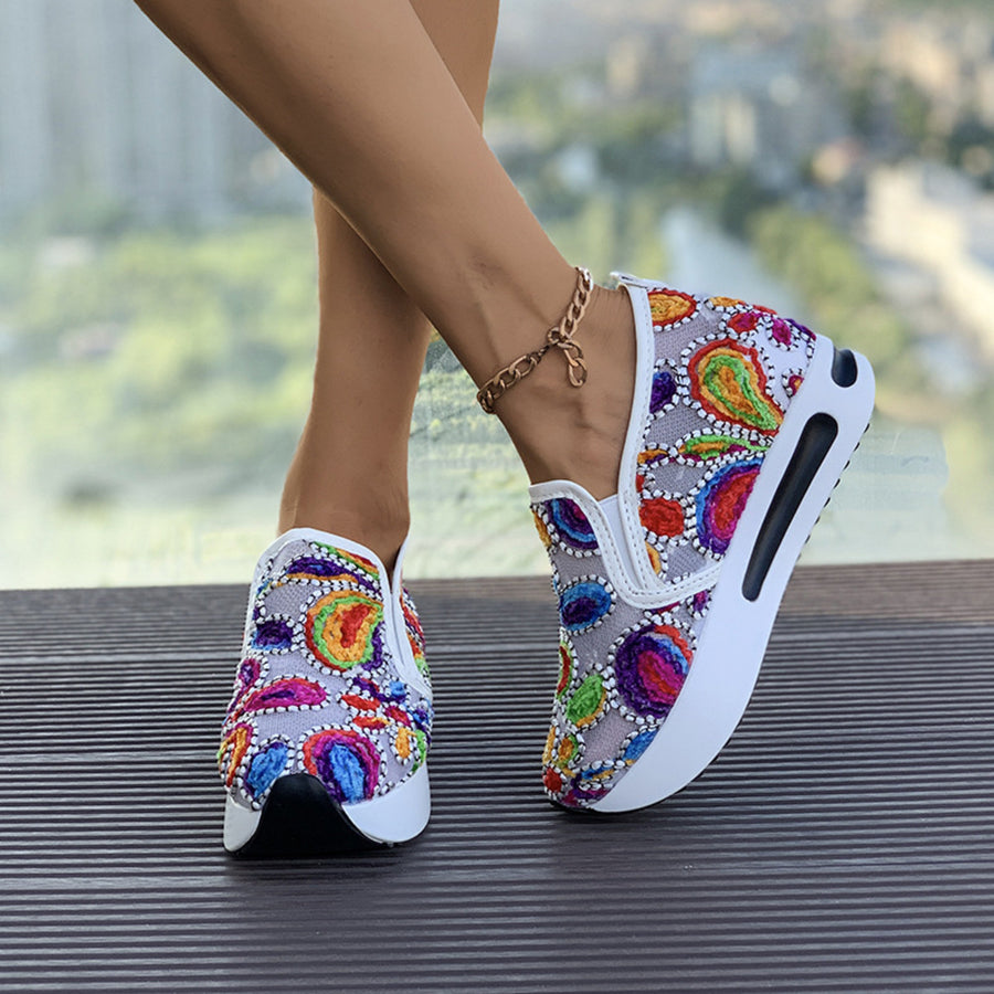 Vibrant slip-on platform sneakers with colorful embroidered paisley pattern.