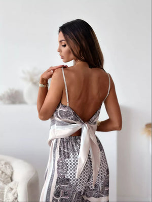 Chic printed cami and wide-leg pants set with a tie-back detail.