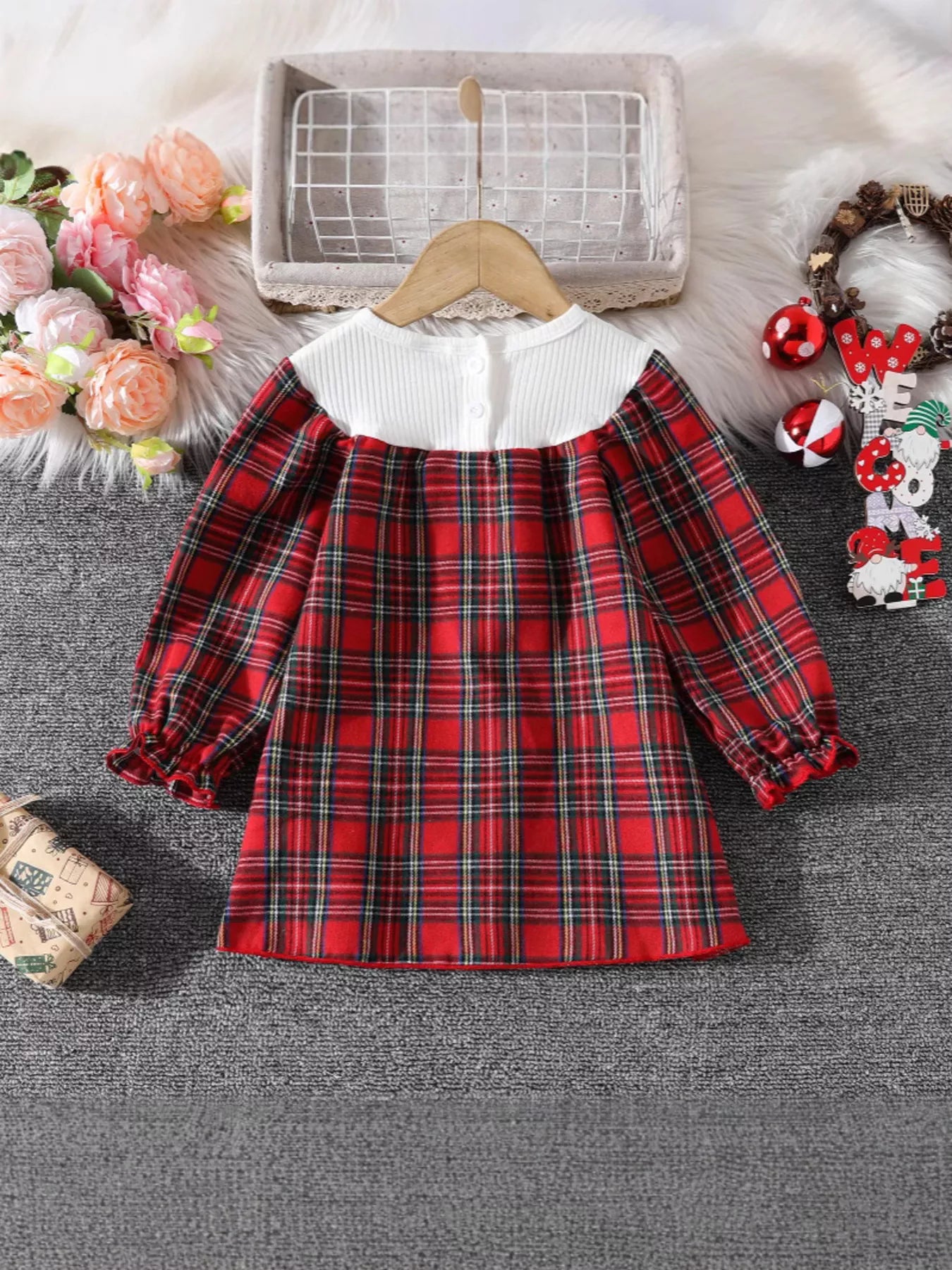 Baby girl's red plaid long-sleeve cotton dress with white ribbed neckline and ruffled cuffs.