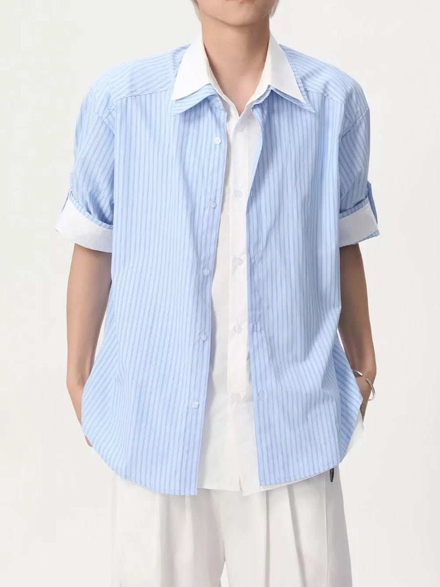 Blue striped casual button-up shirt with white collar and cuffs, layered over a white shirt.