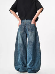 Blue acid-wash wide-leg jeans with a baggy fit and distressed texture.