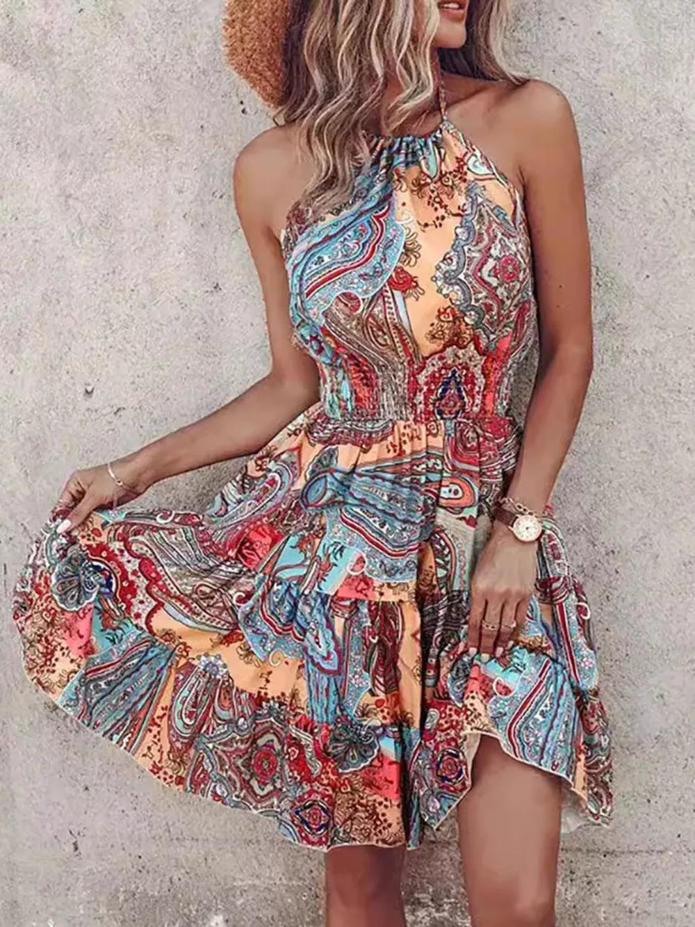 Bohemian printed halter mini dress with tiered skirt in orange and lilac.