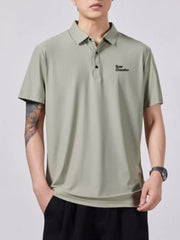 Green short-sleeve cotton polo with button detail and embroidered text.