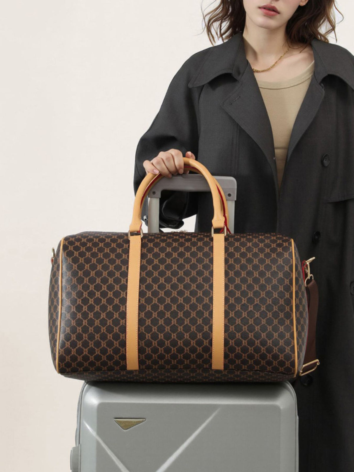 duffle bag in dark brown featuring reinforced handles and barrel fit