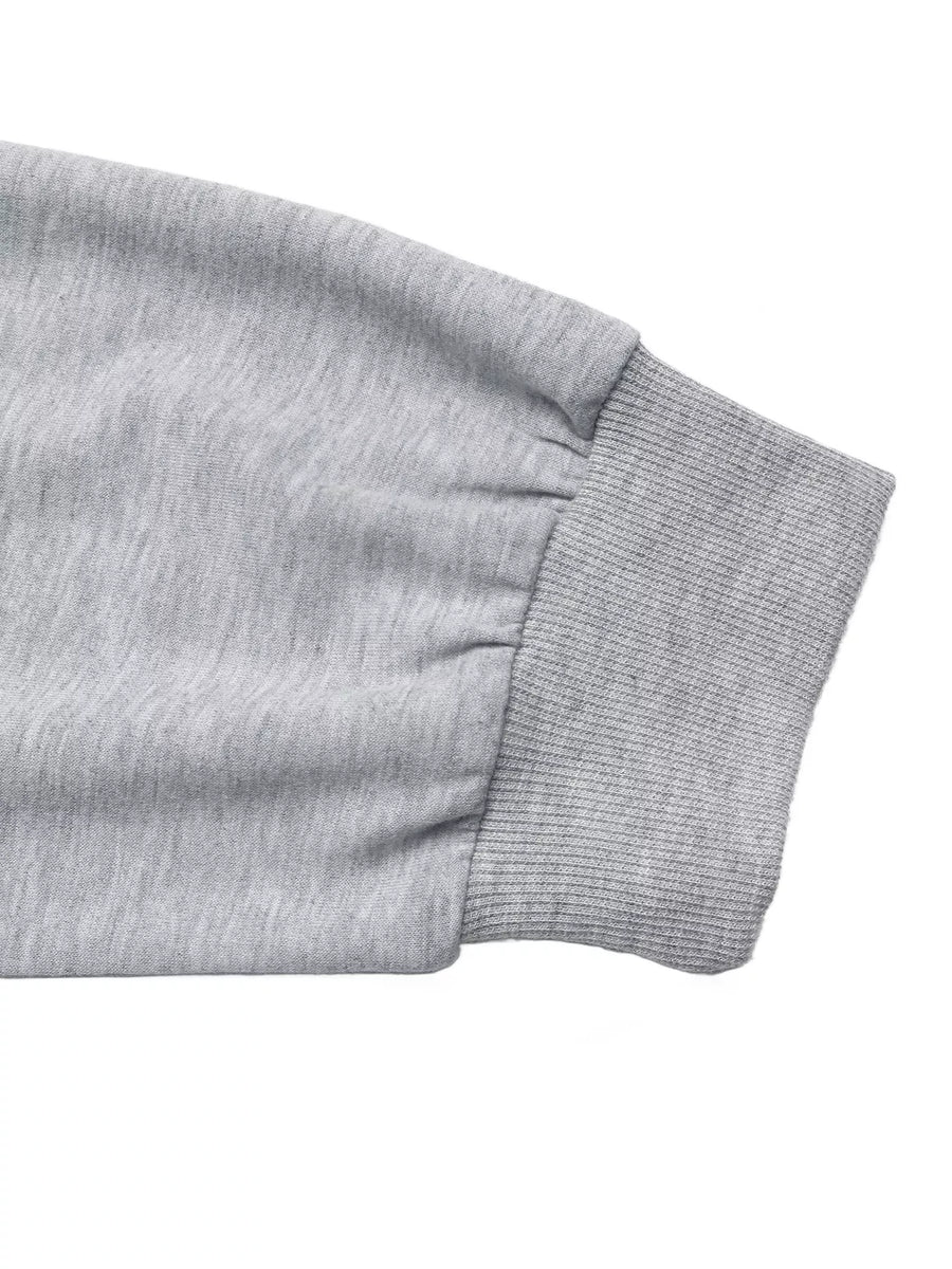 Gray sweater sleeve with ribbed cuff and gathered detail