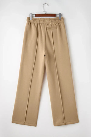 Tan wide-leg sweatpants with relaxed seam detail and elastic waistband.