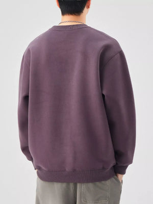 Plus-size long-sleeve sweatshirt in purple with crewneck and ribbed cuffs and hem.