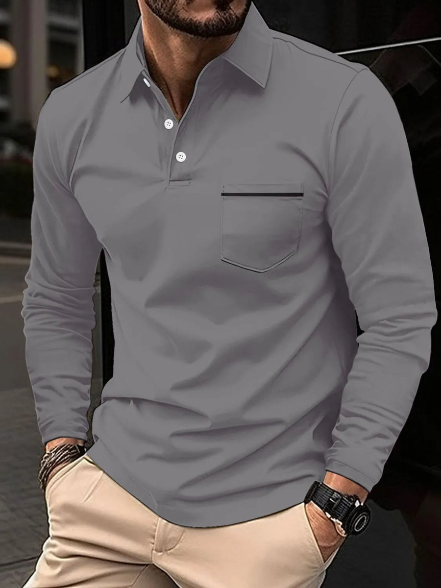 Gray long-sleeve polo shirt with chest pocket and black trim detail.