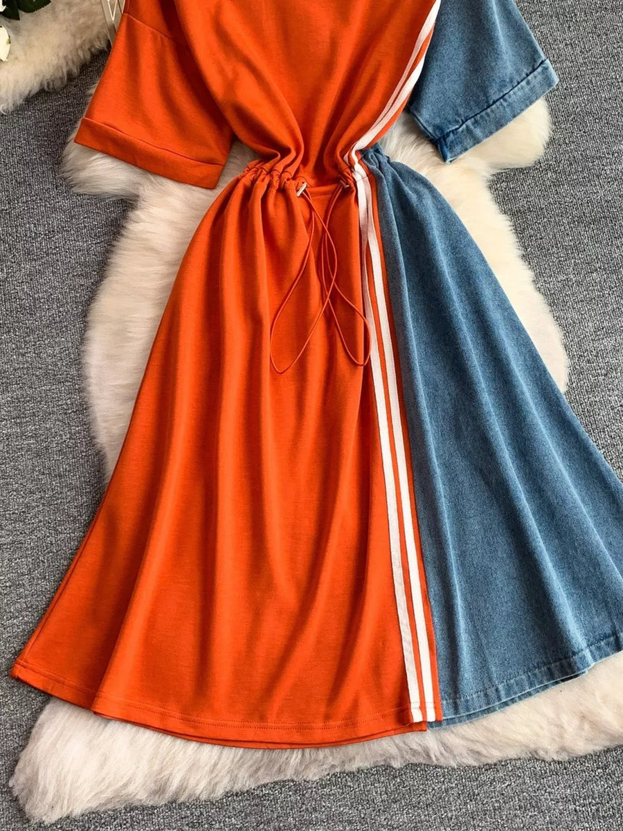 Color block casual dress with drawstring waist, orange and denim panels, and white stripe detail.