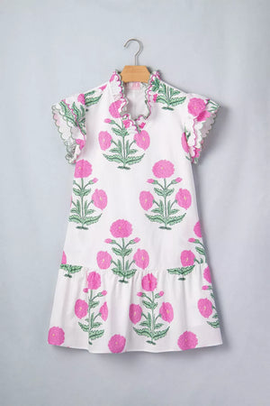 White mini dress with vibrant pink floral print, ruffled neckline and sleeves.