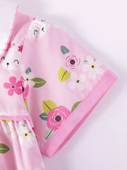 Pink cotton toddler dress with floral bunny print and ruffled collar.