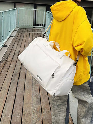 Spacious white canvas travel bag with versatile straps and zippered pockets.