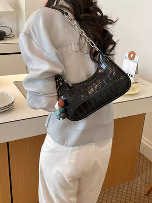 Black shoulder bag with zip-front and crocodile-embossed