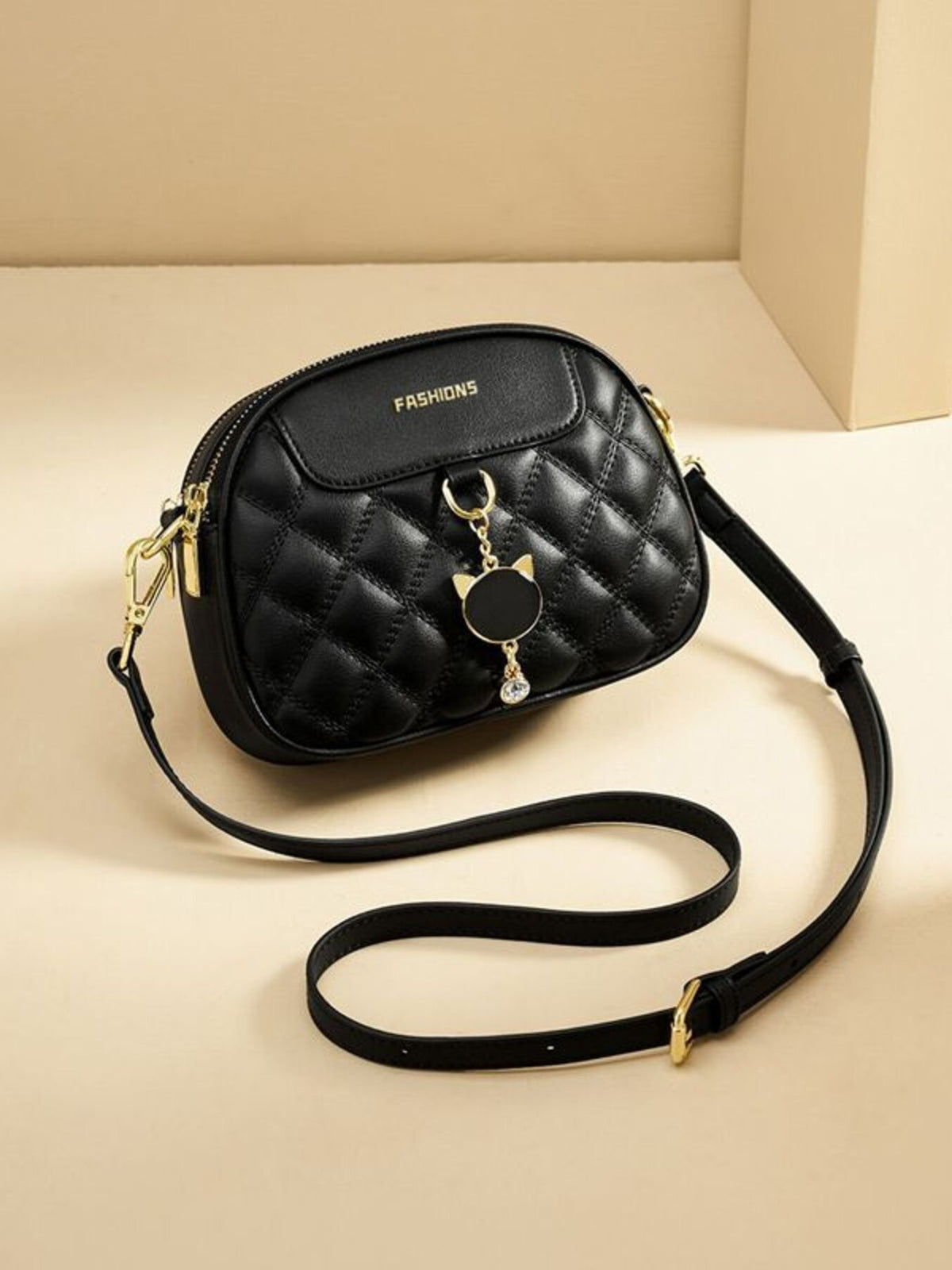 Black quilted PU leather crossbody bag with cat charm and crystal accent