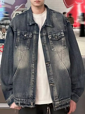 Men's blue vintage washed denim trucker jacket with button front and chest pockets.
